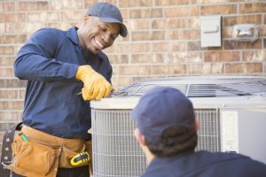 HVAC-technicians-working-on-an-outdoor-AC-unit